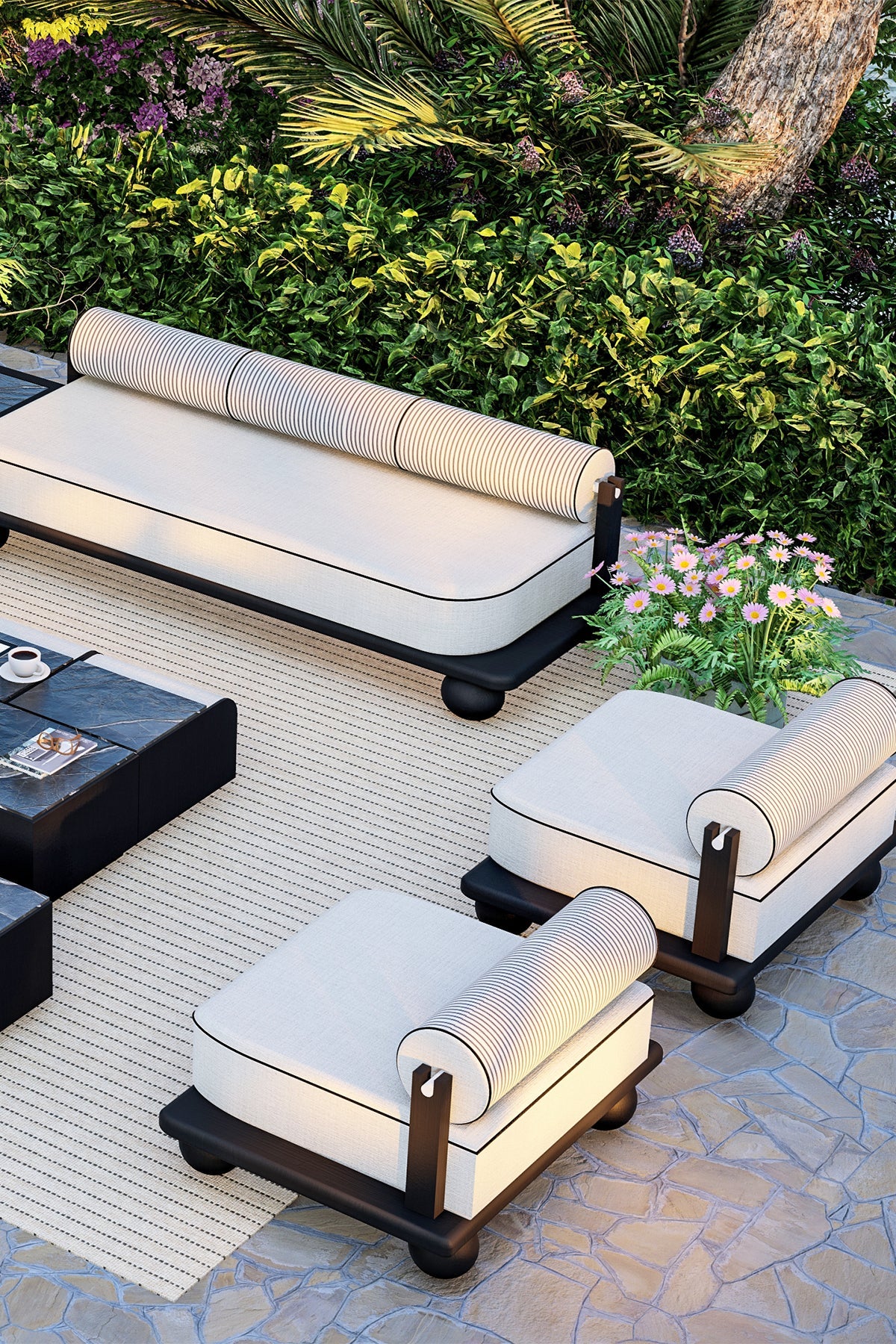Outdoor sofa and chairs with coffee table on striped rug.