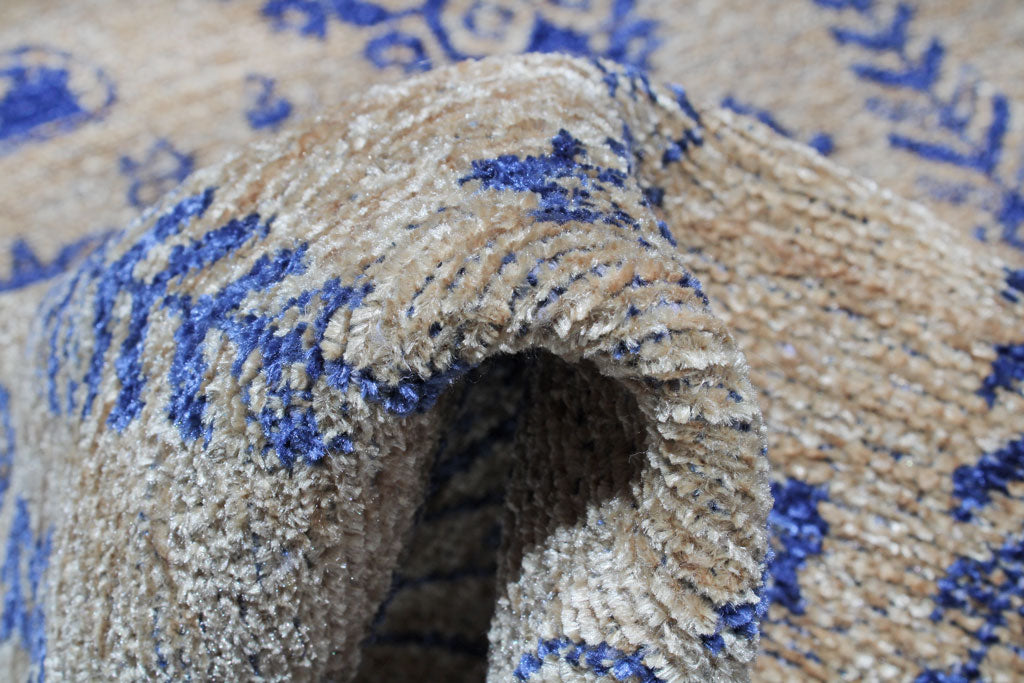 Close up view of beige and blue patterned rug texture