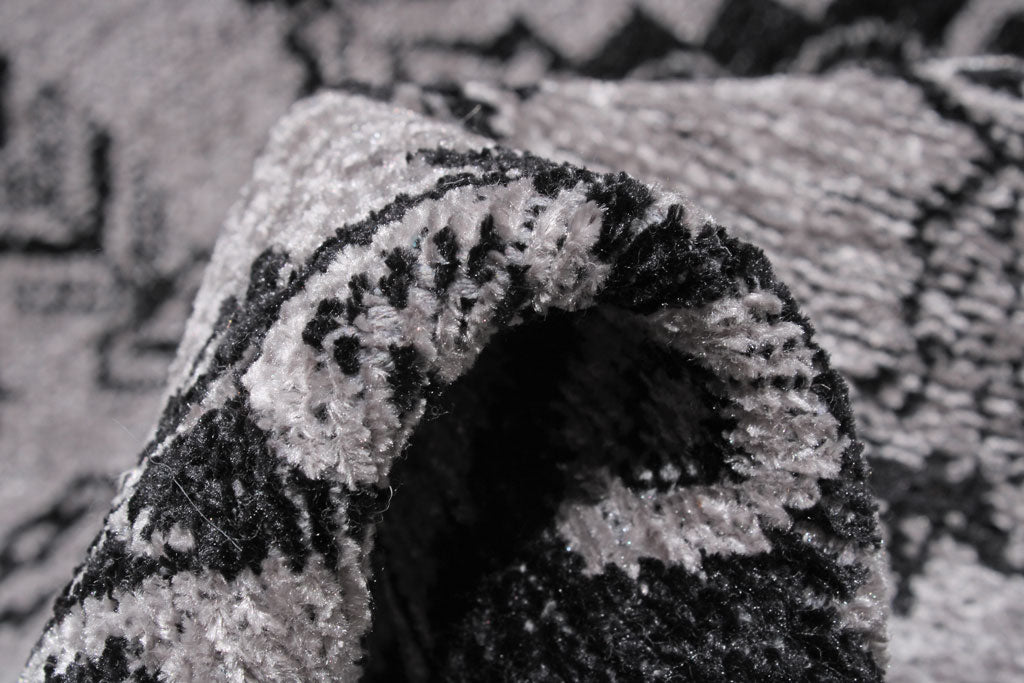 Close up of gray and black patterned rug texture