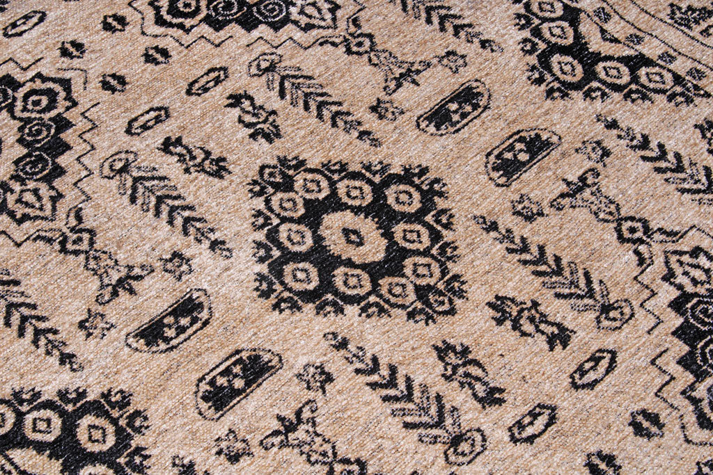 Close up view of beige rug with black geometric pattern
