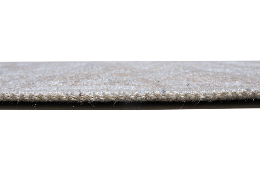 Close up view of beige woven rug edge