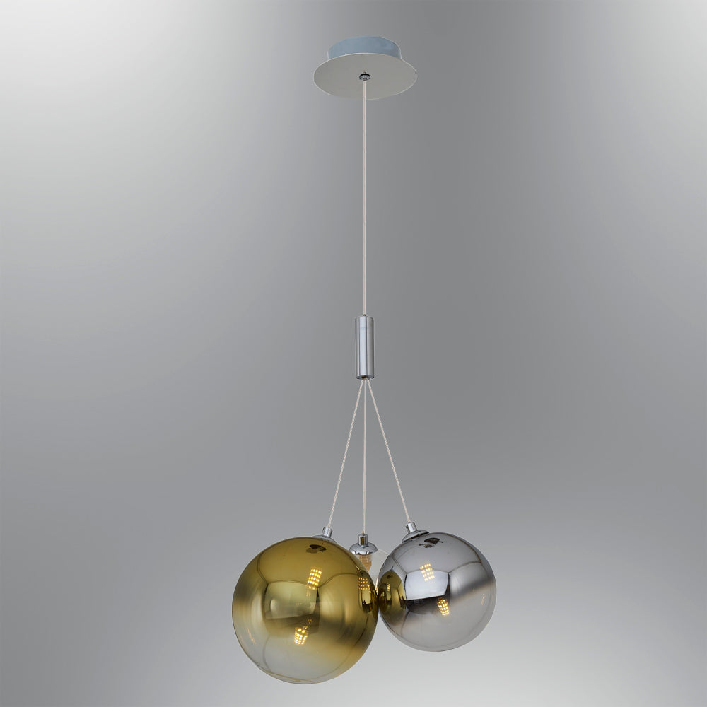 Two metallic sphere pendant lights, one gold, one silver, hanging