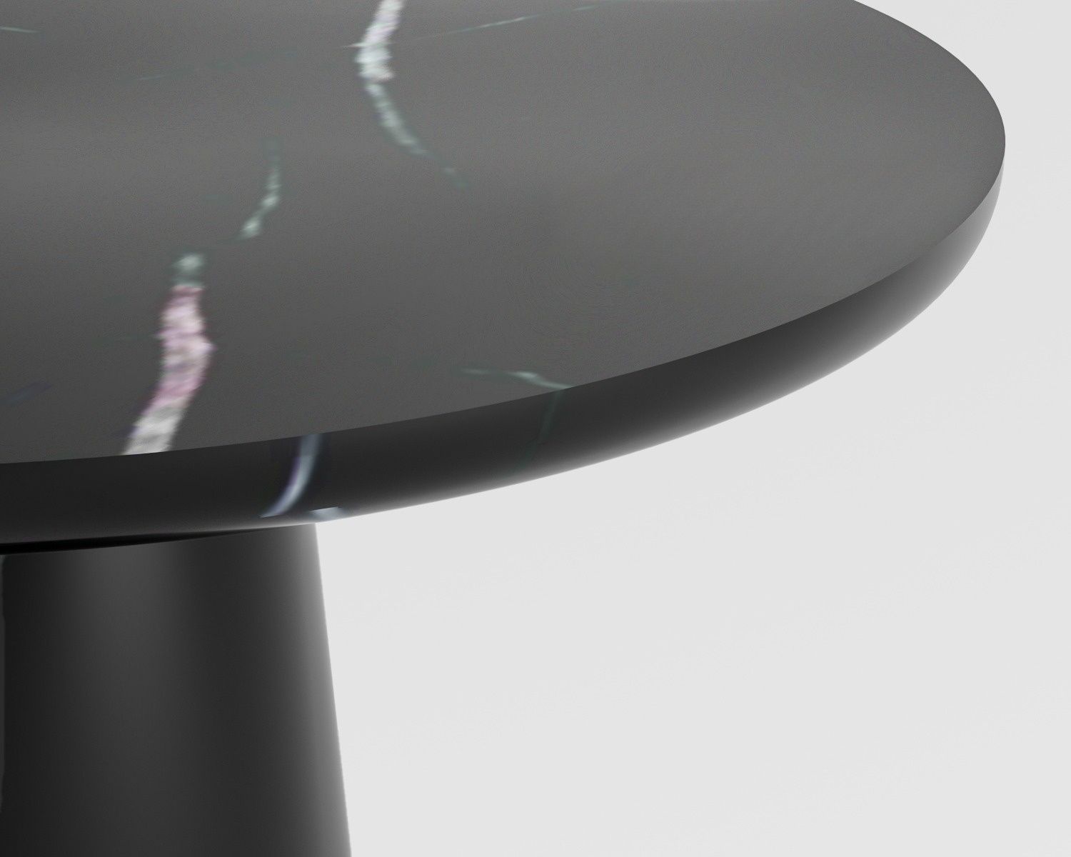 Close-up of Luzione black marble side table. Round top with unique veining, solid pedestal base. Modern accent for living room or bedroom