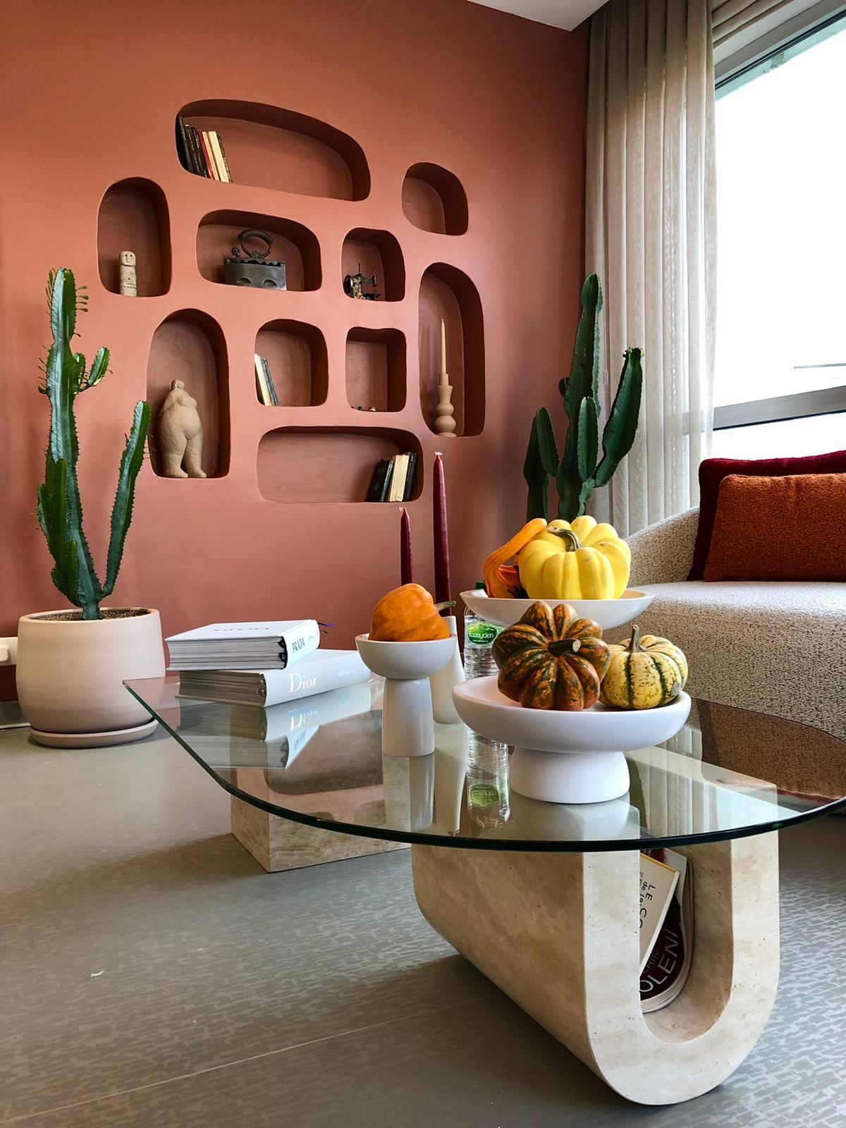 Stylish living room featuring a Luzione U-Shaped marble coffee table, decorative wall, sofa, and fall decor with natural light