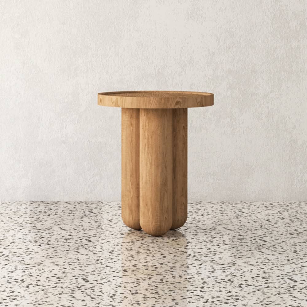 View of wooden side table with three cylindrical legs on terrazzo floor