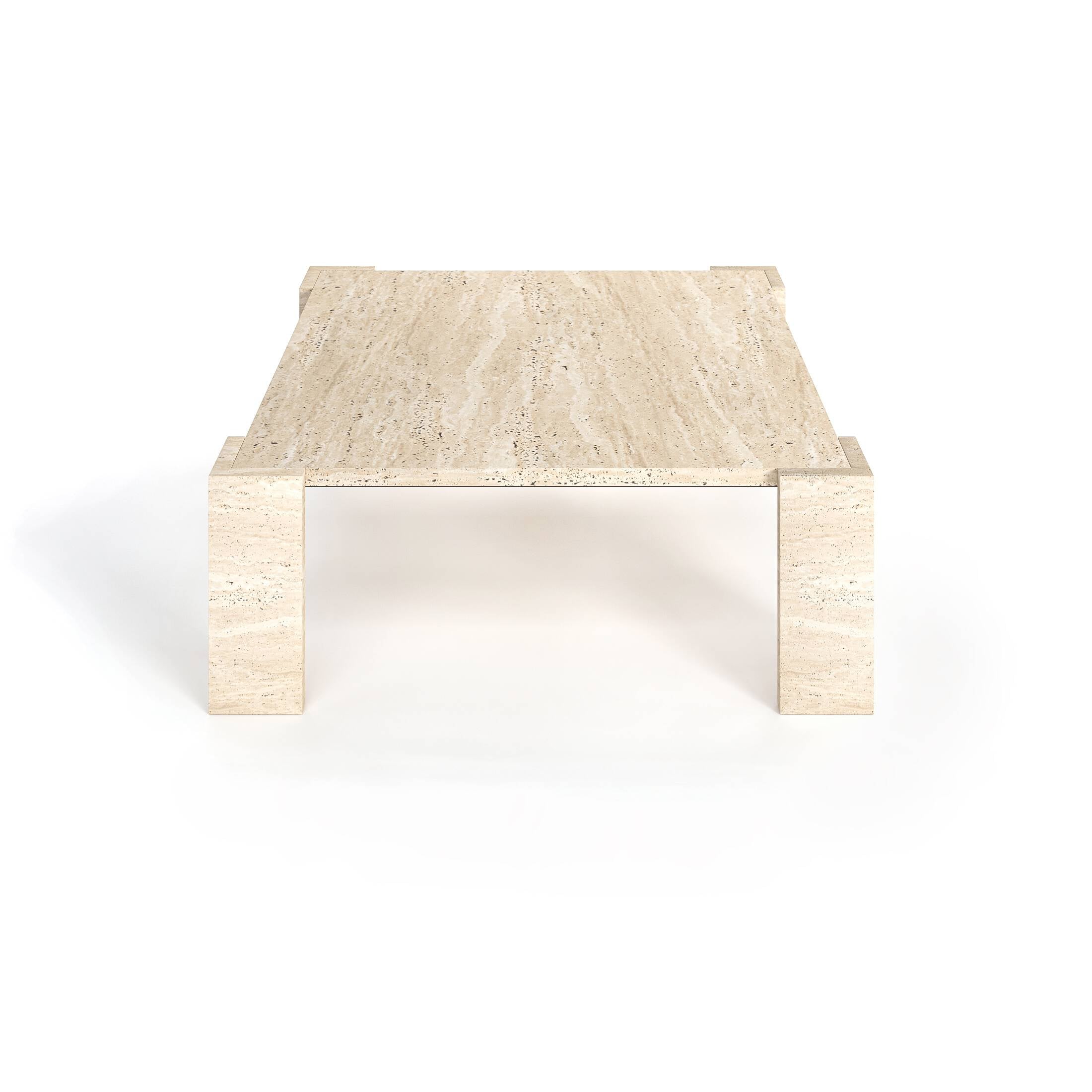 Luzione travertine coffee table with square top and V-shaped block legs. Modern stone furniture for minimalist living rooms