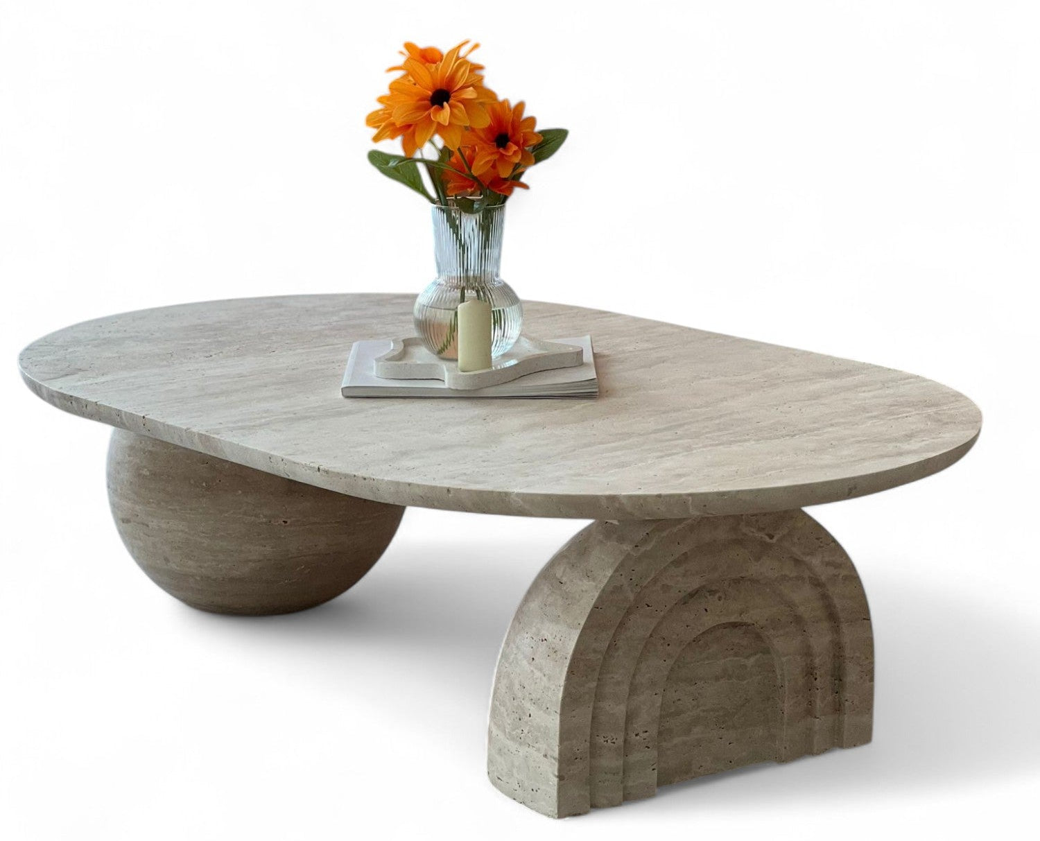 Studio shot of oval travertine coffee table with flowers and candle, furniture, home decor, natural stone, modern design, living room table, beige marble, sculptural base, unique shape, interior styling