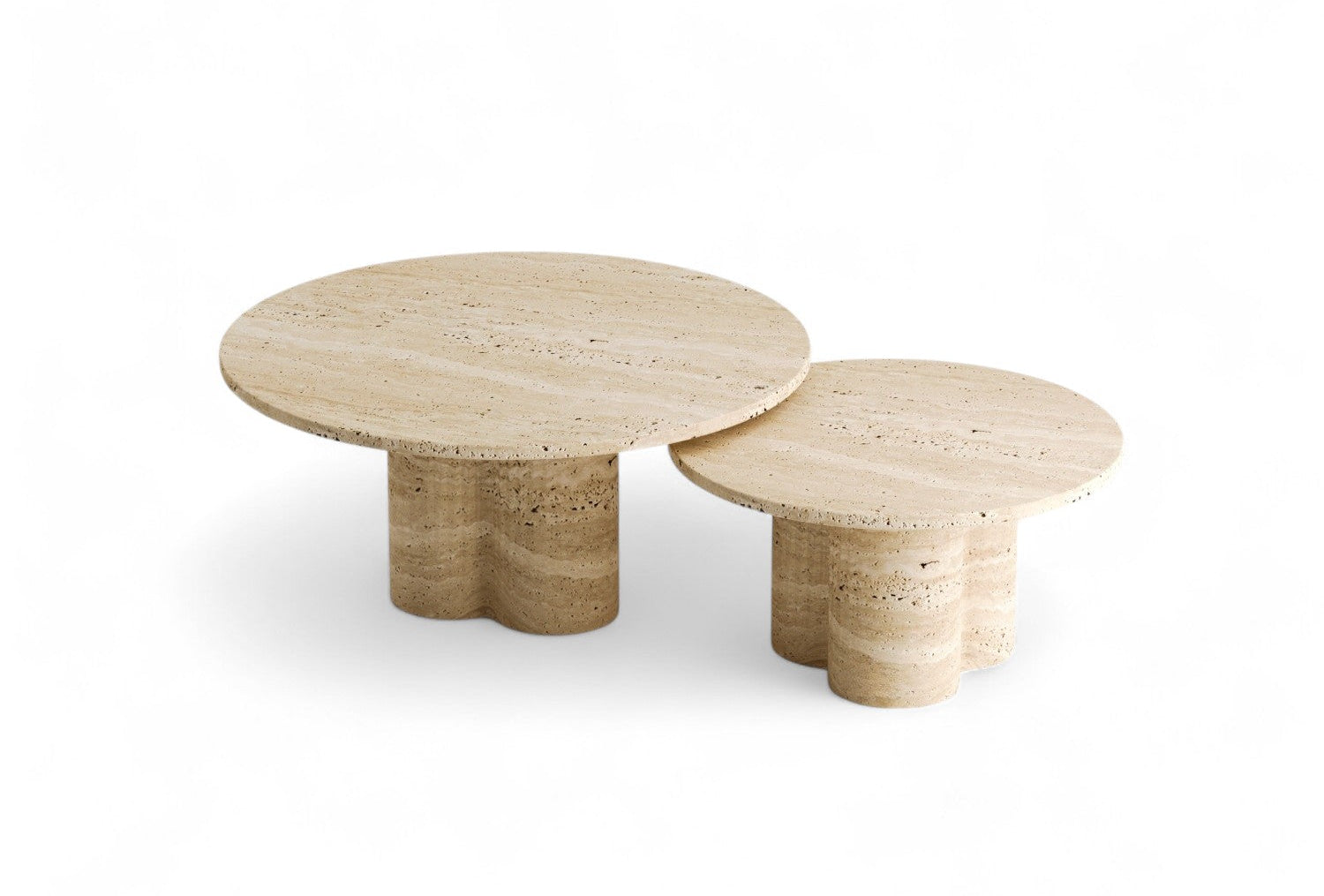 Studio shot of two nesting travertine coffee tables with round tops