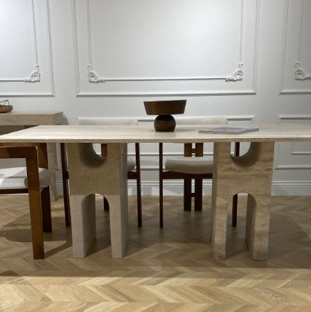 Luzione Kaze modern travertine dining table with unique leg design paired with modern dining chairs in a luxury dining room setting
