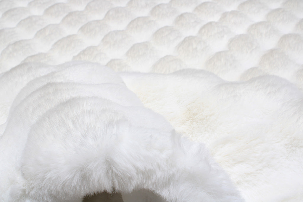 Close up view white faux fur rug scalloped texture