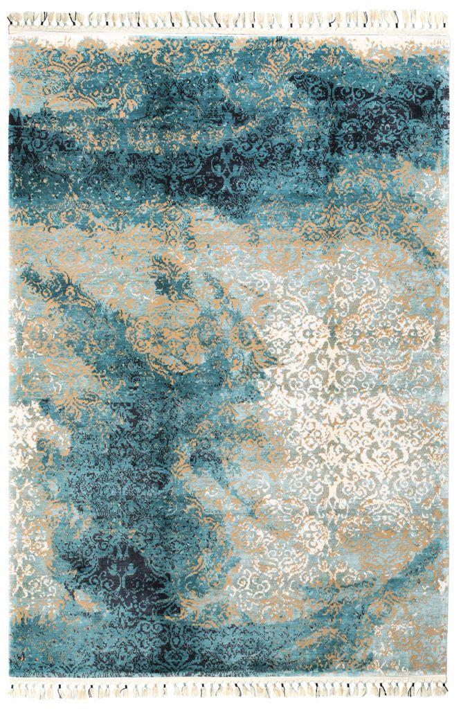 Abstract patterned area rug with blue, tan, and white colors