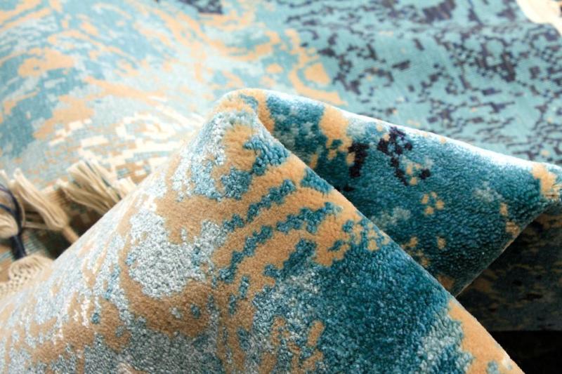 Close up view of abstract patterned rug with tassels
