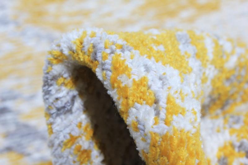 Close up of yellow and white patterned rug edge
