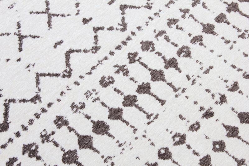 White and brown patterned area rug close up view