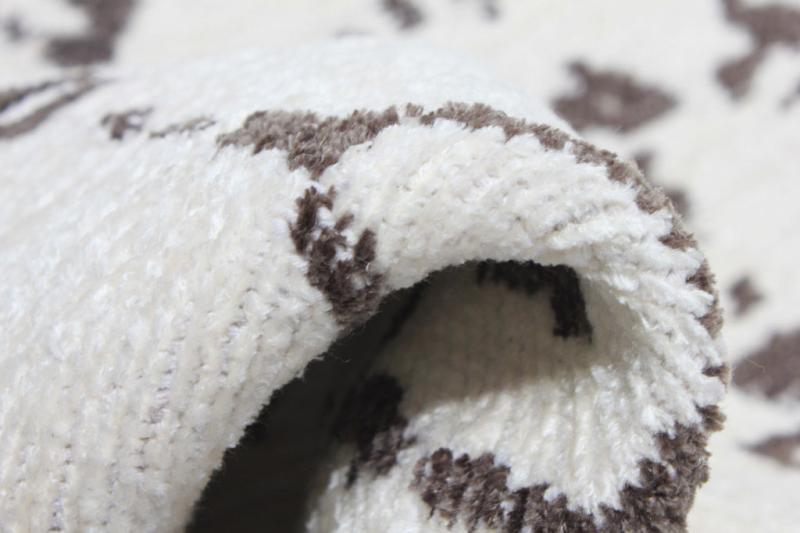 Close up view of white and brown patterned rug texture
