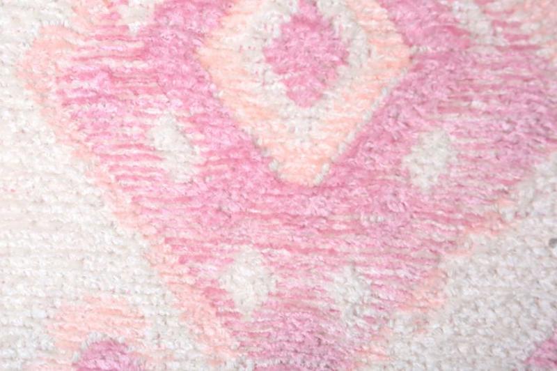 Close up pink and white patterned rug texture