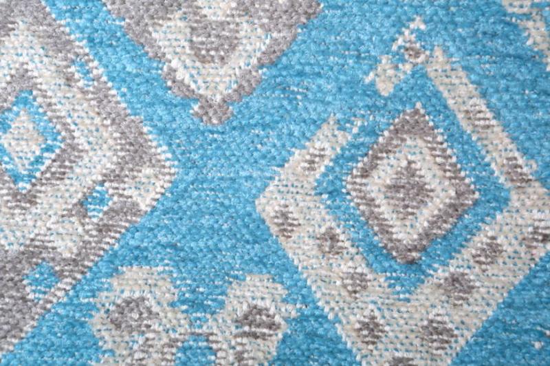 close up of blue gray diamond pattern rug