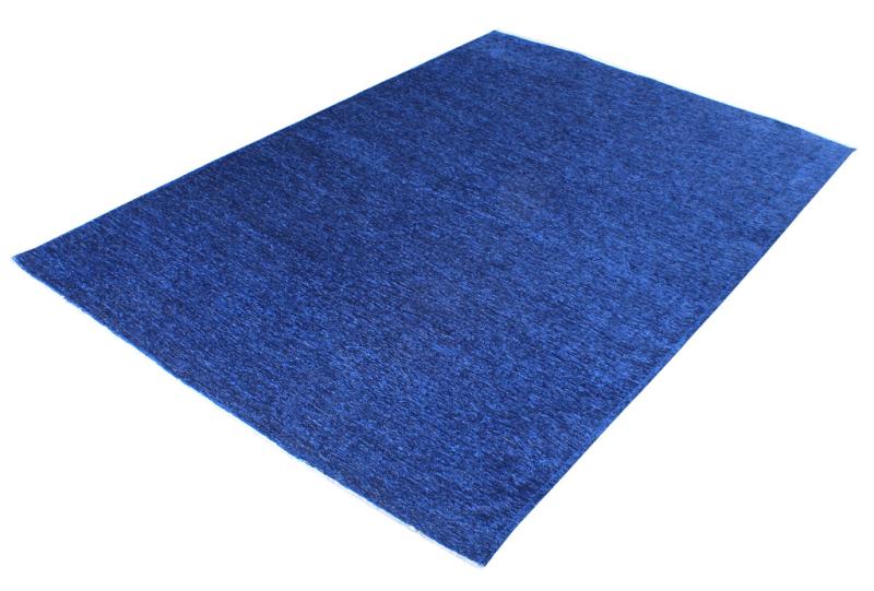 An angled view of the Moretti Plain Rug can be placed in a living room, emphasizing its seamless integration into minimalist interiors.