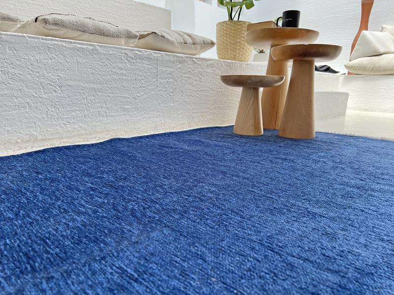 Angled view of Moretti Plain Rug placed in a living room, emphasizing its seamless integration into minimalist interiors.