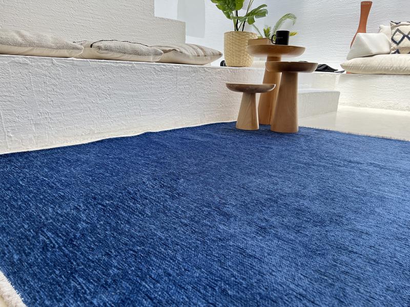 Moretti Plain Rug displayed in a serene bedroom, illustrating its calming neutral tones.