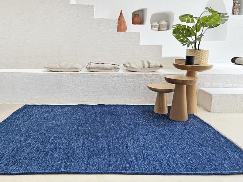 Angled view of Moretti Plain Rug placed in a living room, emphasizing its seamless integration into minimalist interiors.
