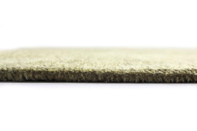 Moretti Plain Rug placed in a tranquil reading nook, adding warmth and simplicity to the space.