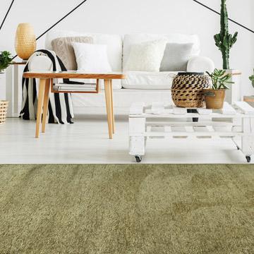 Moretti Plain Rug placed in a tranquil reading nook, adding warmth and simplicity to the space.
