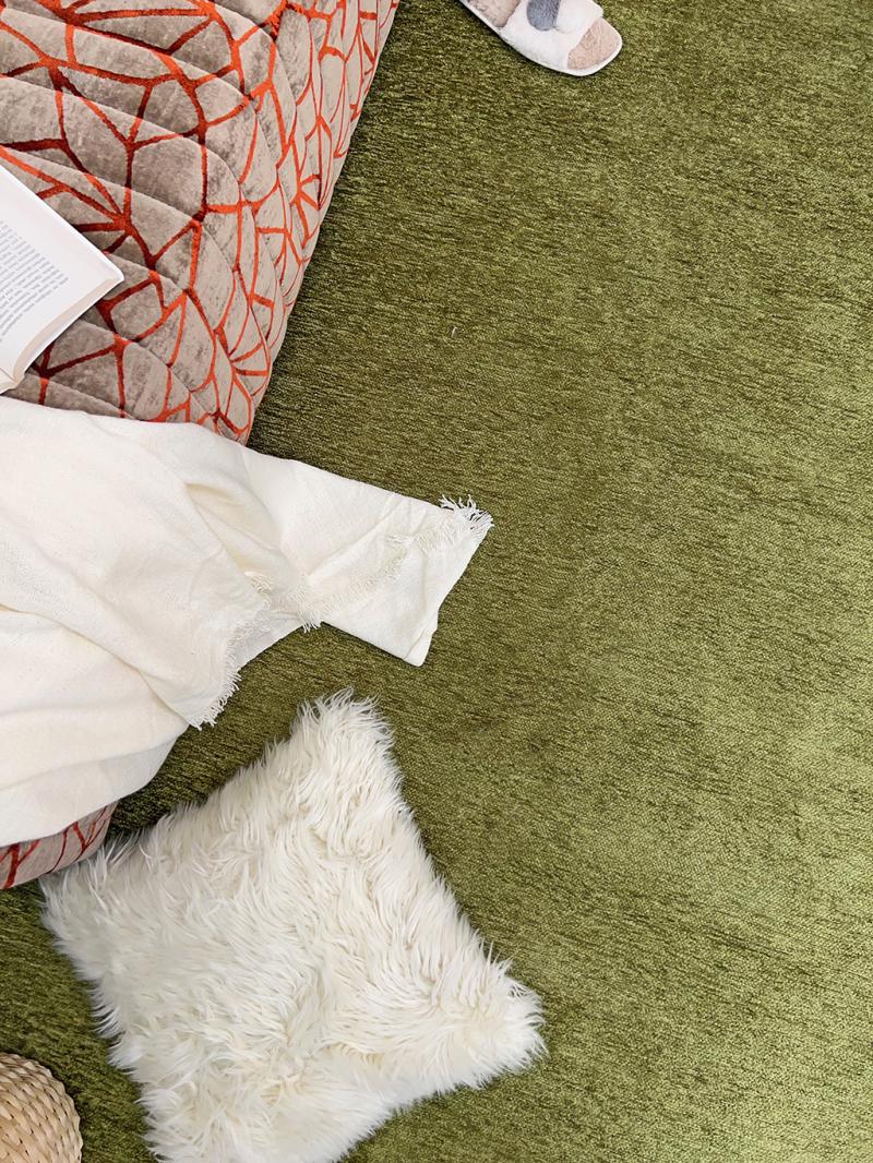 Moretti Plain Rug placed in a tranquil reading nook, adding warmth and simplicity to the space.