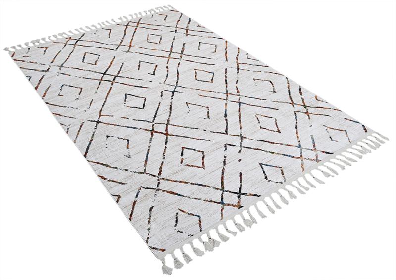 Overhead view of white rug with brown diamond pattern and tassels