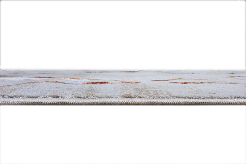 Close up view of white patterned area rug edge