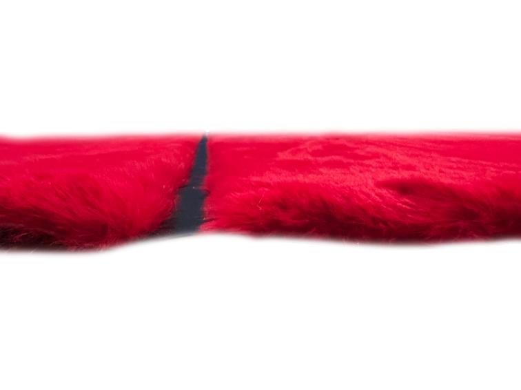 Angled view of Rabbit Fur Rug under a modern coffee table, highlighting its bold design in a stylish setting.