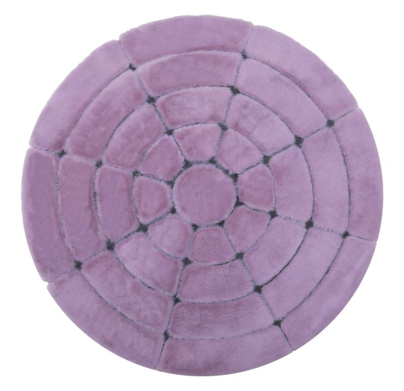 Front view of Rabbit Round Fur Rug in rose and black colors, serving as a sophisticated accent in a cozy living room.