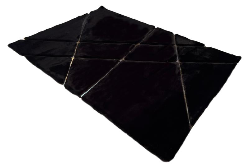 Close-up of Rabbit Fur Rug's black and gold fur, showcasing the opulence of its design.