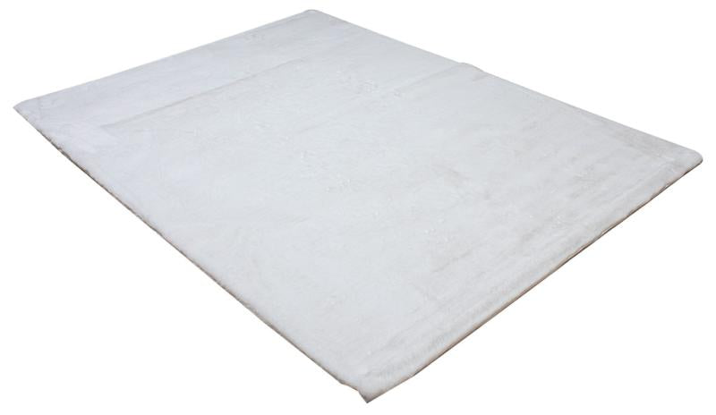 Close-up of Rabbit Fur Rug's pristine white fibers, emphasizing its softness and elegance.