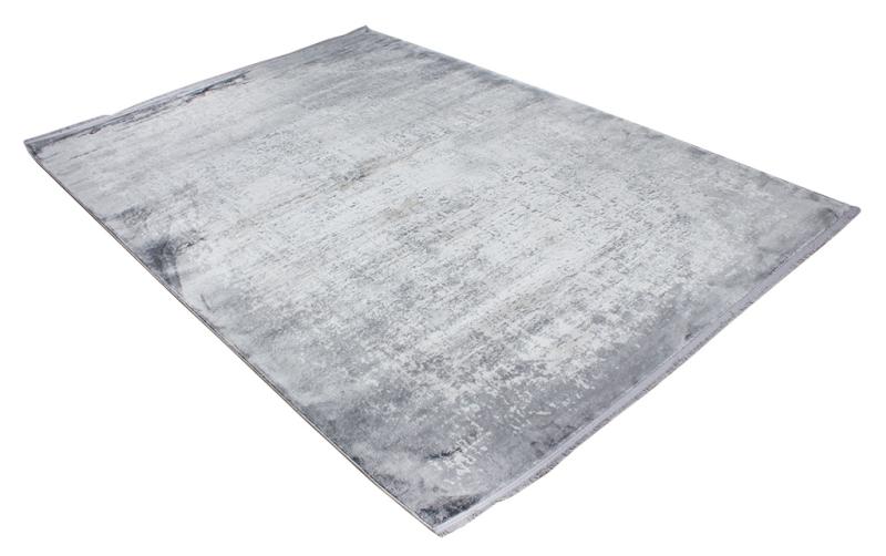 Overhead view of a rectangular gray and white abstract area rug on a white background.