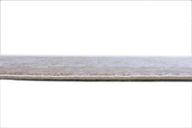 Close up view of beige area rug edge and texture