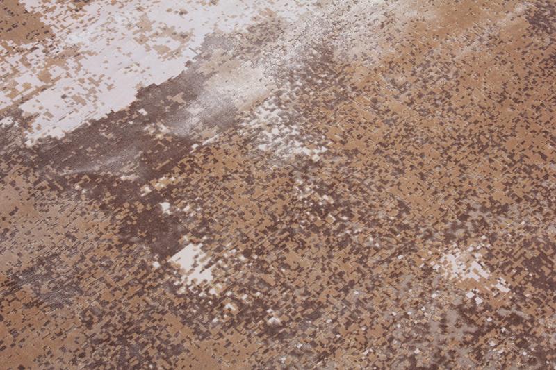 Close up view of brown and beige abstract patterned rug