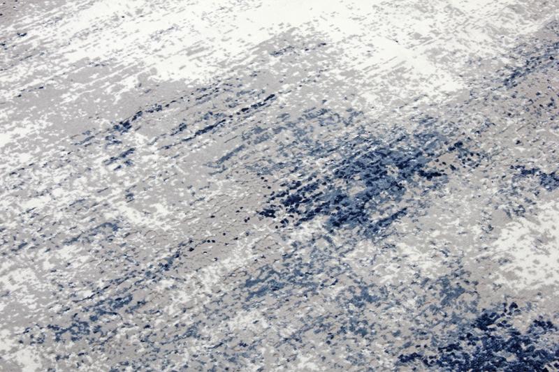 Lizy Rug displayed in a modern living area, serving as a focal point with its vibrant blue design.