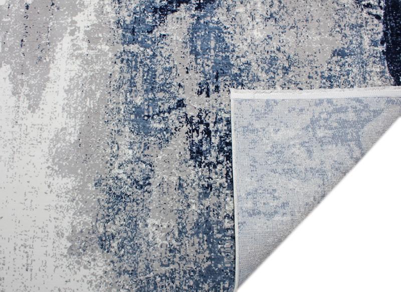 Lizy Rug displayed in a modern living area, serving as a focal point with its vibrant blue design.