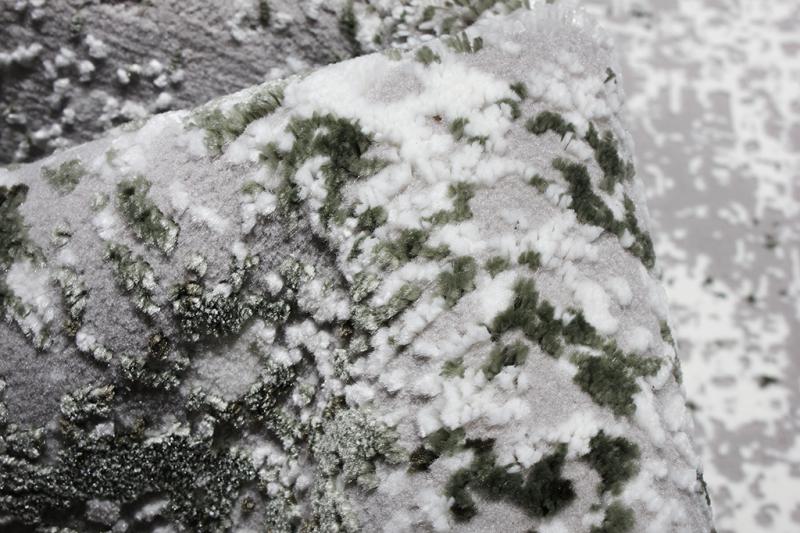 Close up view of gray white green patterned rug texture