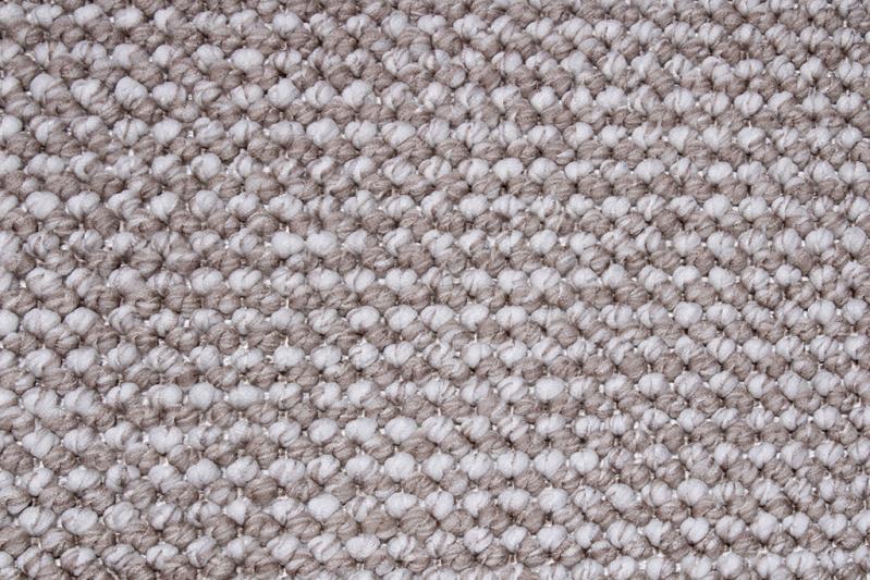 Close up view of gray and white textured woven rug