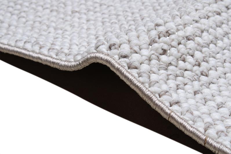 Close up view of white and gray woven rug edge