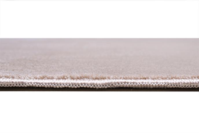 Angled view of Infiniti Rug under furniture, illustrating its seamless fit into diverse interior styles.