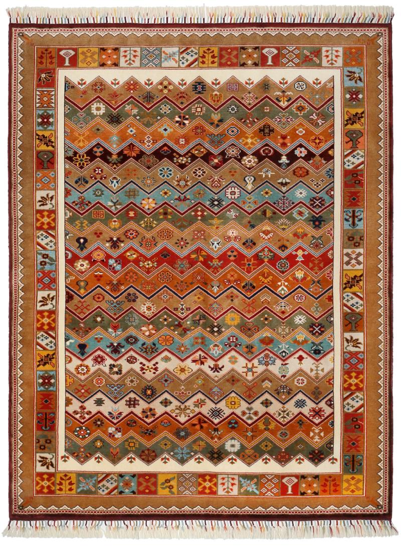 Overhead view of colorful zigzag patterned area rug with fringe.