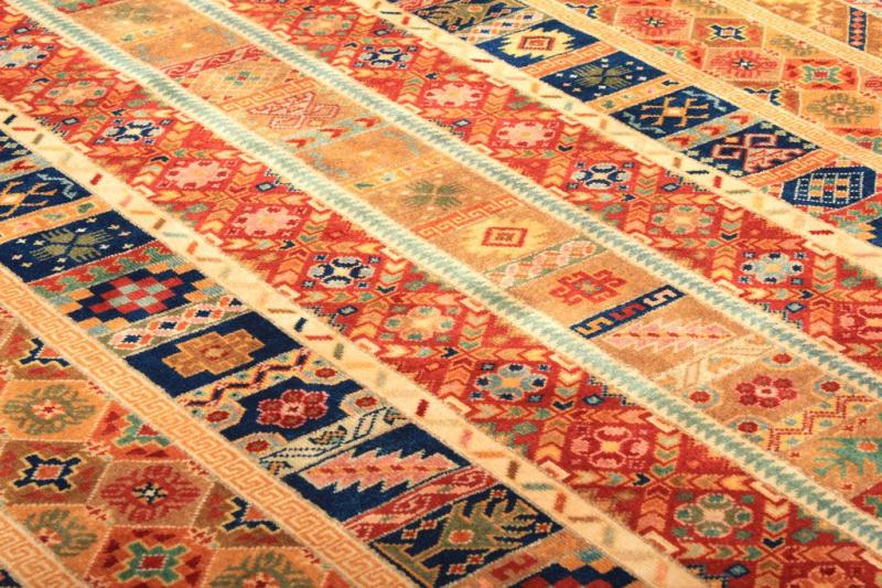 Close up view of colorful patterned area rug with diagonal stripes