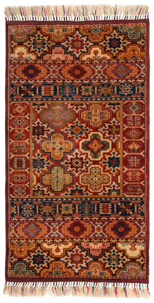 Overhead view of a rectangular multicolored traditional patterned area rug with fringe