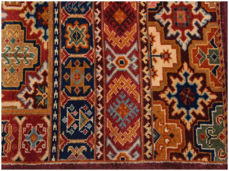 Close up view of colorful patterned area rug with geometric designs