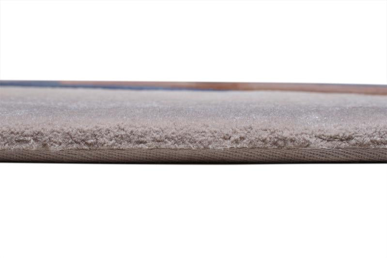Angled view of Circle Tufted Rug under a glass coffee table, illustrating its ability to complement upscale decor.