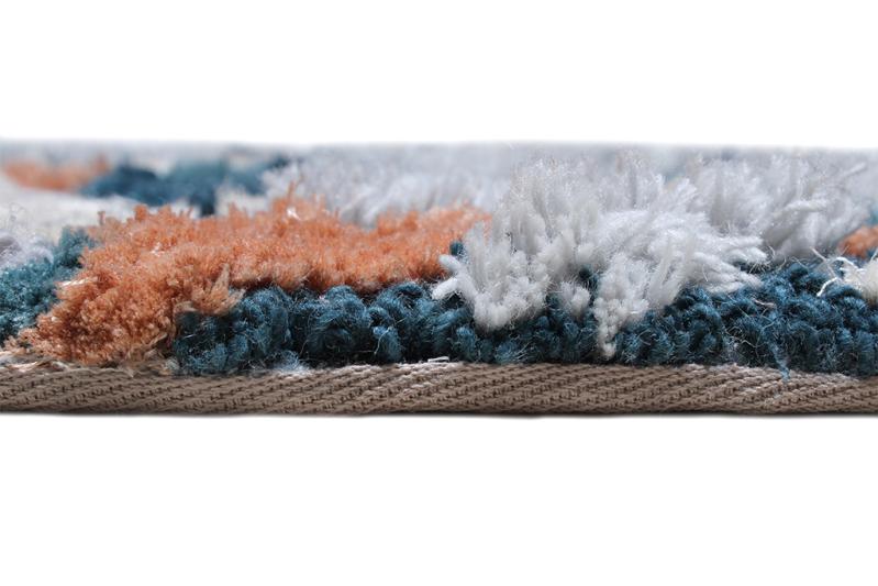Close-up of the Luzione 902 Rock Tufted Rug showcasing its plush blue, orange, and white shag texture, perfect for adding warmth and style