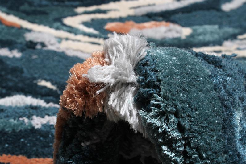 Close-up of Luzione 902 Rock Tufted Rug featuring a modern abstract design with blue, orange, and white colors, adding depth and style